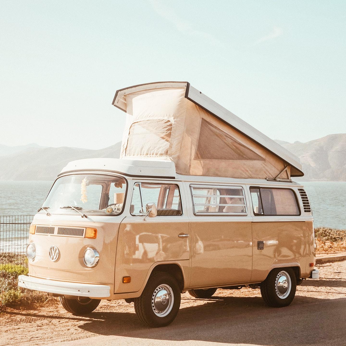 brown Volkswagen T1 van near body of water at daytime